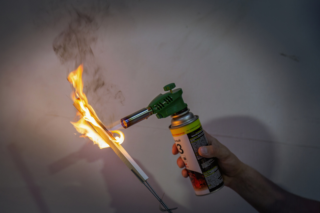 A worker checks the product for fire resistance